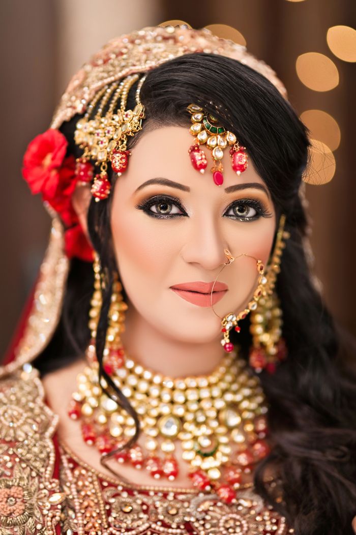 Beautiful South Asian bride adorned with traditional jewelry and makeup.