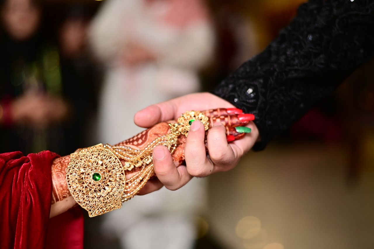A detailed view of traditional henna design and jewelry at a Pakistani wedding in Sialkot.